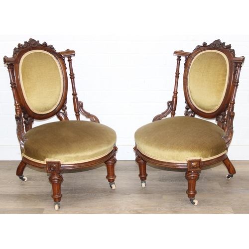 85 - A pair of decorative shield back armchairs with exposed carved frames and ceramic castors, 19th cent... 