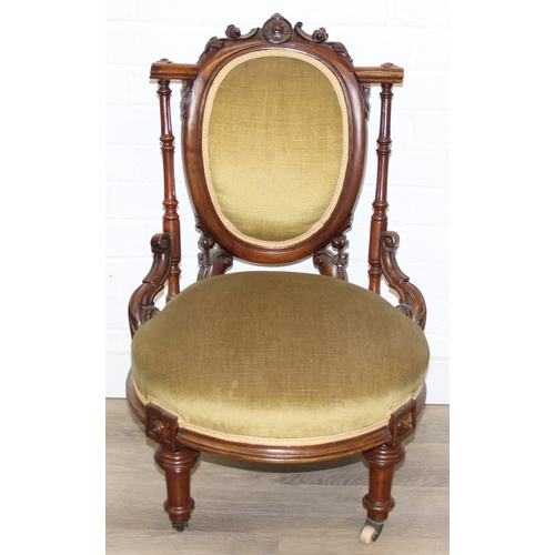 85 - A pair of decorative shield back armchairs with exposed carved frames and ceramic castors, 19th cent... 