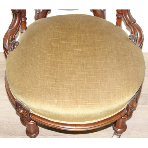 85 - A pair of decorative shield back armchairs with exposed carved frames and ceramic castors, 19th cent... 