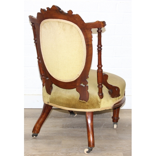 85 - A pair of decorative shield back armchairs with exposed carved frames and ceramic castors, 19th cent... 