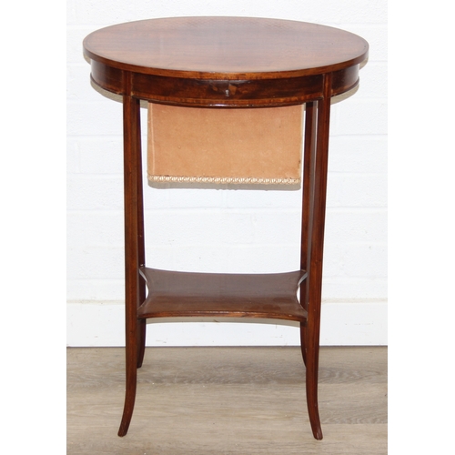 35 - An Edwardian mahogany sewing table of oval form, with lift up top and fabric basket, 49cm x 35cm x 7... 