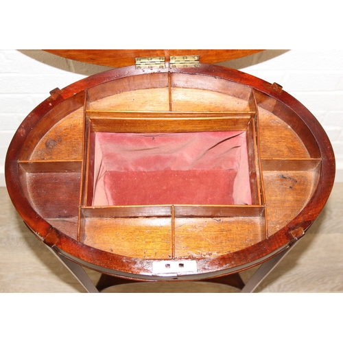 35 - An Edwardian mahogany sewing table of oval form, with lift up top and fabric basket, 49cm x 35cm x 7... 