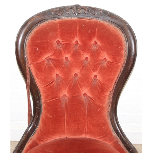 74 - A 19th century low chair with shaped button back and exposed carved frame, 87cm tall