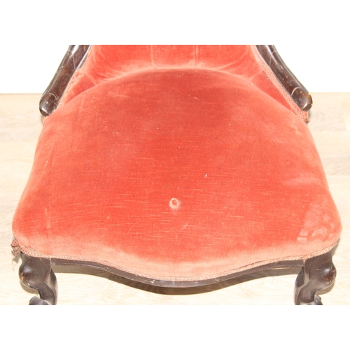 74 - A 19th century low chair with shaped button back and exposed carved frame, 87cm tall