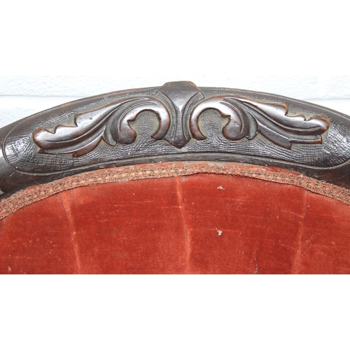 74 - A 19th century low chair with shaped button back and exposed carved frame, 87cm tall