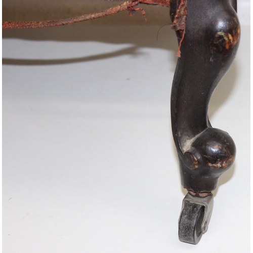 74 - A 19th century low chair with shaped button back and exposed carved frame, 87cm tall