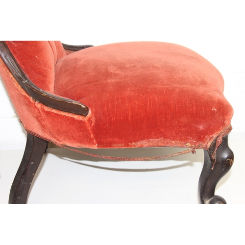 74 - A 19th century low chair with shaped button back and exposed carved frame, 87cm tall