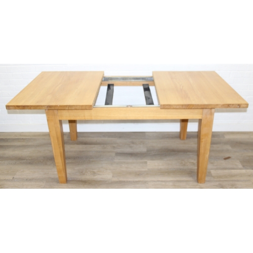 73 - A modern light oak extending dining table with single extra leaf, 133cm extending to 169cm x 92cm x ... 