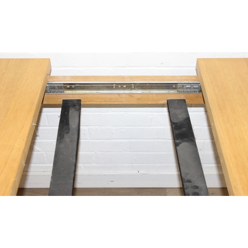 73 - A modern light oak extending dining table with single extra leaf, 133cm extending to 169cm x 92cm x ... 