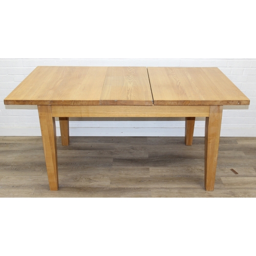 73 - A modern light oak extending dining table with single extra leaf, 133cm extending to 169cm x 92cm x ... 