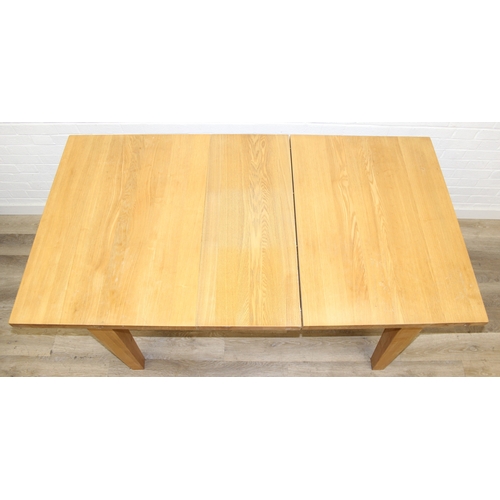 73 - A modern light oak extending dining table with single extra leaf, 133cm extending to 169cm x 92cm x ... 