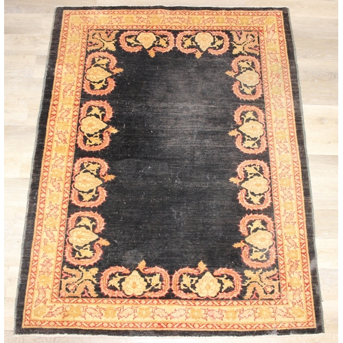 200 - A vintage Afghan rug of black ground with decorative gold border, label verso marked Zigler, 192cm x... 