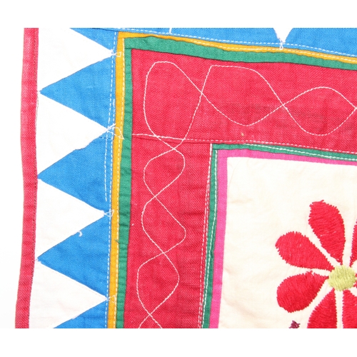 209 - A vintage Indian Toran or Kutch style embroidered wall hanging decorated with colourful flowers and ... 