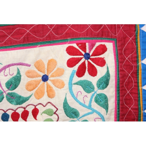209 - A vintage Indian Toran or Kutch style embroidered wall hanging decorated with colourful flowers and ... 