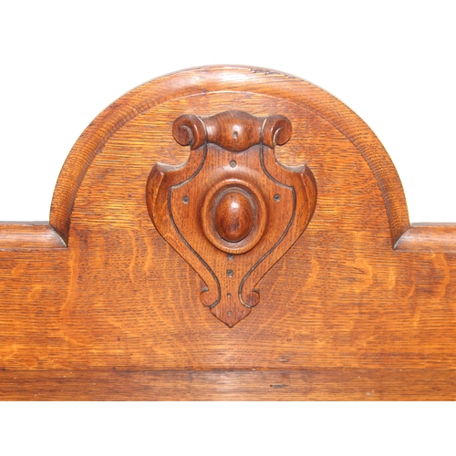 75 - An antique oak two tier buffet stand with cupboard base and carved frieze to top, late 19th or early... 