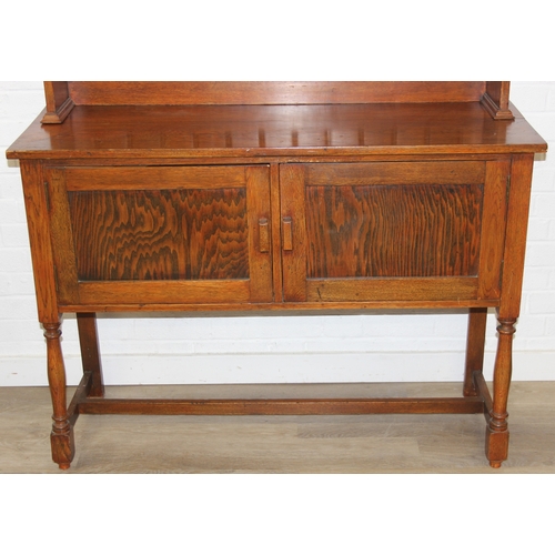 42 - An early 20th century oak two part dresser with cupboard base and open top, 122cm x 44cm x 185cm