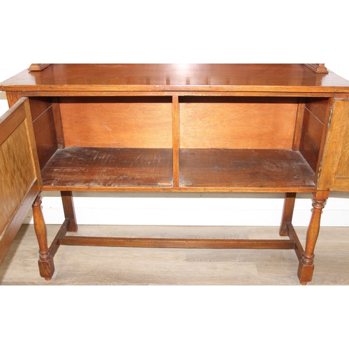 42 - An early 20th century oak two part dresser with cupboard base and open top, 122cm x 44cm x 185cm