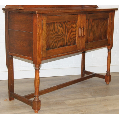 42 - An early 20th century oak two part dresser with cupboard base and open top, 122cm x 44cm x 185cm
