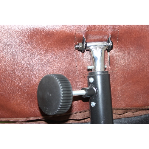 11 - An Ekornes style brown leather reclining armchair with matching footstool, splayed base, 76cm wide x... 