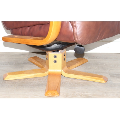 11 - An Ekornes style brown leather reclining armchair with matching footstool, splayed base, 76cm wide x... 