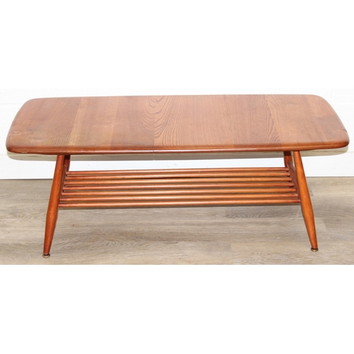 17 - A retro Ercol coffee table with magazine rack, golden dawn type finish, 104cm x 45cm x 37cm