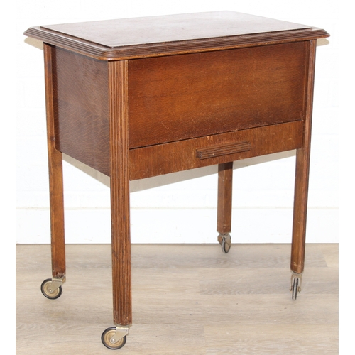 109 - A vintage oak sewing box on wheels with vintage contents inc cotton reels, 56cm x 37cm x 62cm