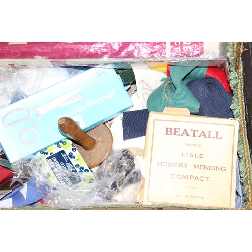 109 - A vintage oak sewing box on wheels with vintage contents inc cotton reels, 56cm x 37cm x 62cm