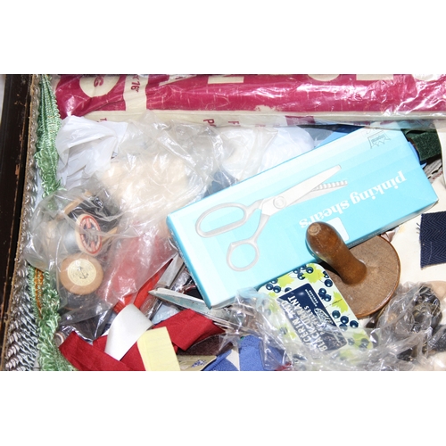 109 - A vintage oak sewing box on wheels with vintage contents inc cotton reels, 56cm x 37cm x 62cm