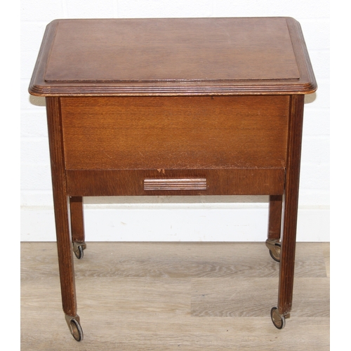 109 - A vintage oak sewing box on wheels with vintage contents inc cotton reels, 56cm x 37cm x 62cm