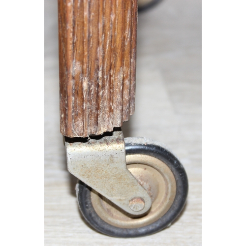 109 - A vintage oak sewing box on wheels with vintage contents inc cotton reels, 56cm x 37cm x 62cm