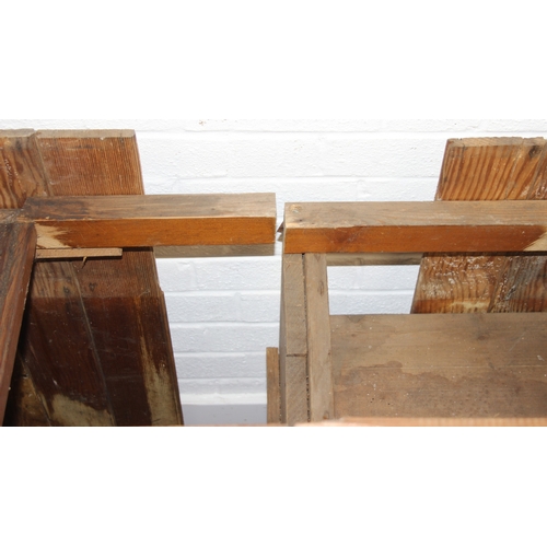 61 - A large antique pine dresser base comprising of three deep drawers with turned handles over four cup... 