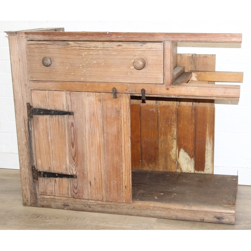 61 - A large antique pine dresser base comprising of three deep drawers with turned handles over four cup... 
