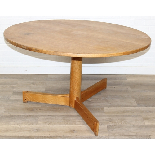 99 - A modern light oak dining table with pillar support and tripod base, 124cm in diameter x 71cm tall
