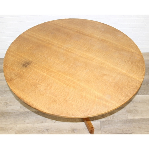 99 - A modern light oak dining table with pillar support and tripod base, 124cm in diameter x 71cm tall