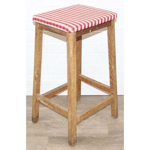 114A - Two vintage light oak stools with red gingham upholstery, each 63cm tall