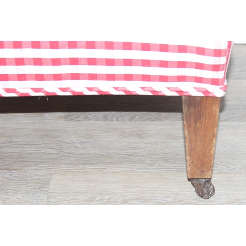 114 - An antique mahogany chaises longue with exposed frame and red gingham upholstery, 130cm x 60cm x 90c... 