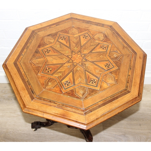 108 - An antique specimen wood parquetry inlaid octagonal topped table with intricately carved triple pill... 