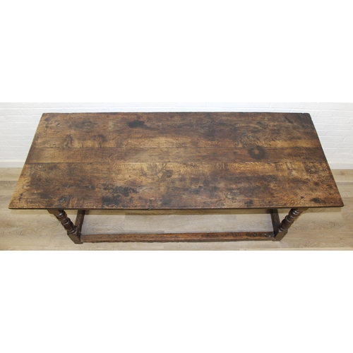 5 - A 17th century and later oak refectory table with turned legs and stretchers, the base likely 17th c... 