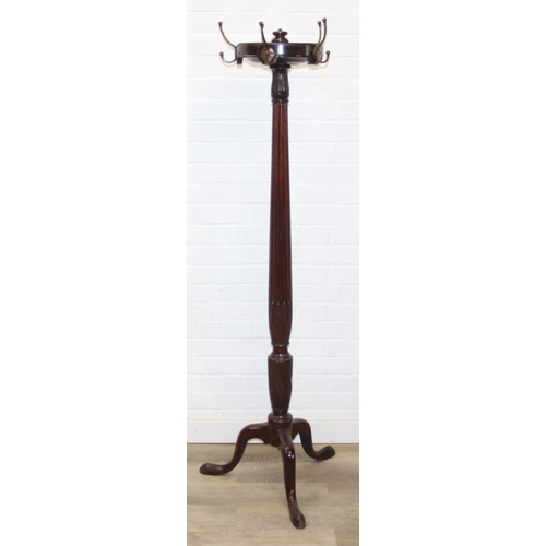 65 - An antique mahogany coat stand with reeded pillar and carved with wheat sheaths, five brass hooks an... 
