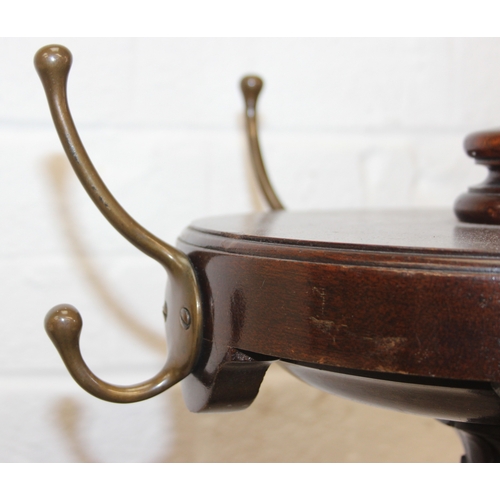 65 - An antique mahogany coat stand with reeded pillar and carved with wheat sheaths, five brass hooks an... 