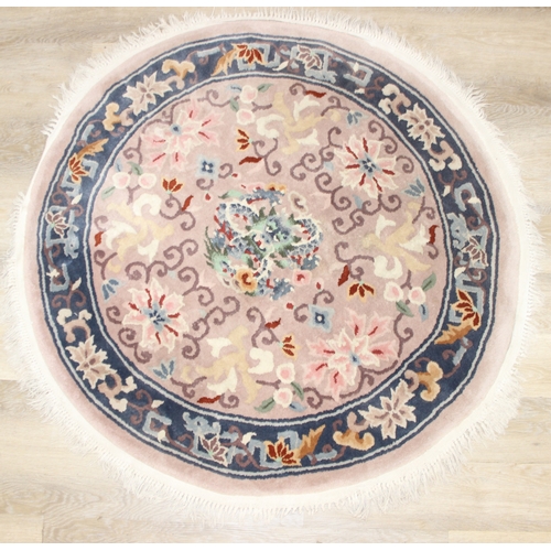 211 - Two circular Chinese wool rugs, one salmon ground, the other russet, each 140cm in diameter [2]