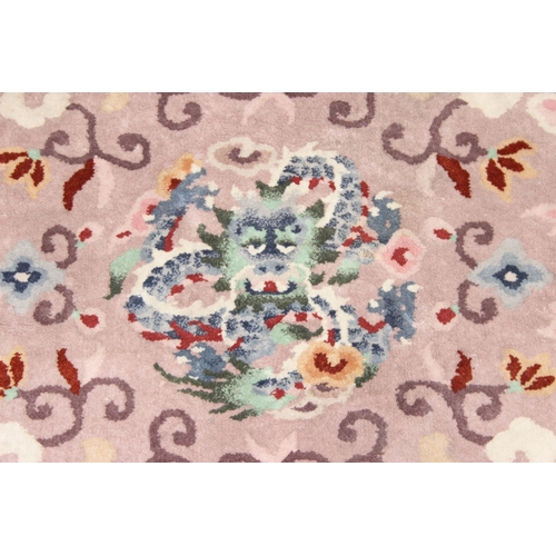 211 - Two circular Chinese wool rugs, one salmon ground, the other russet, each 140cm in diameter [2]