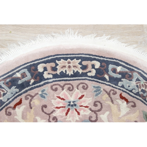 211 - Two circular Chinese wool rugs, one salmon ground, the other russet, each 140cm in diameter [2]