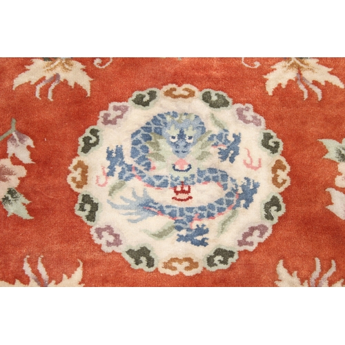 211 - Two circular Chinese wool rugs, one salmon ground, the other russet, each 140cm in diameter [2]