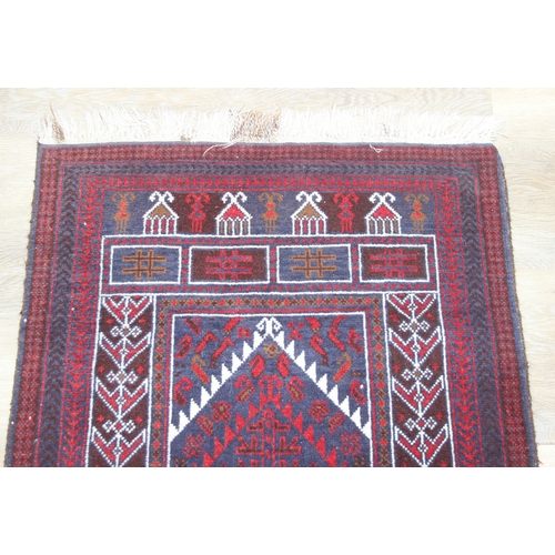 212 - A vintage Afghan Balucch prayer rug of red ground, 155cm x 86cm