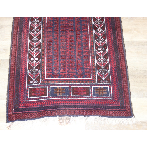 212 - A vintage Afghan Balucch prayer rug of red ground, 155cm x 86cm