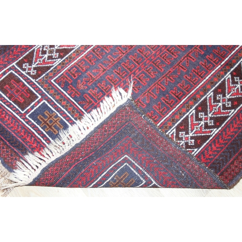 212 - A vintage Afghan Balucch prayer rug of red ground, 155cm x 86cm