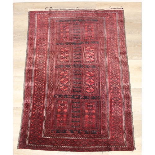213 - A vintage Turkoman rug of red ground, 155cm x 105cm