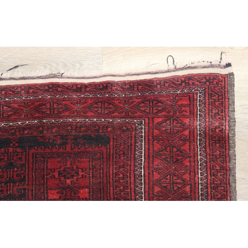 213 - A vintage Turkoman rug of red ground, 155cm x 105cm