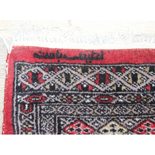 214 - A red ground Uzbek style Bukhara rug, made in Pakistan, 138cm x 94cm